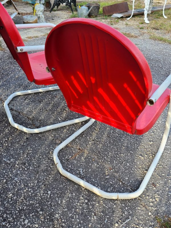 Back view of matching set of red outside chairs