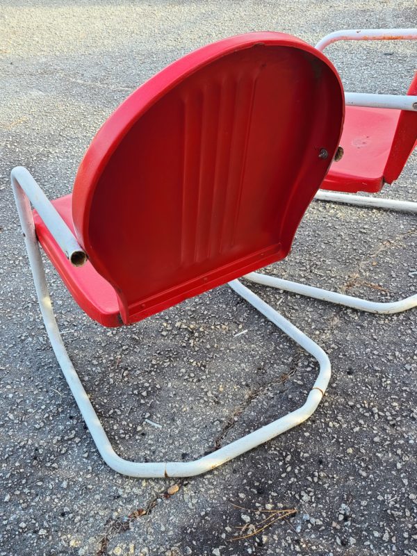 Back view of matching set of red outside chairs